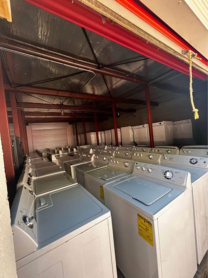 Rows of top-load washers and dryers in stock