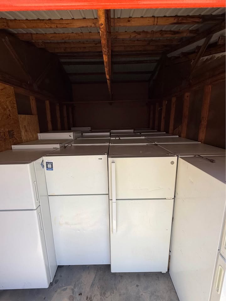 White top-freezer refrigerators stocked in the warehouse